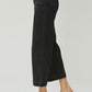 Side view of RISEN High Rise Wide Leg Ankle Jeans in black, showcasing a chic, cropped silhouette with stylish footwear.