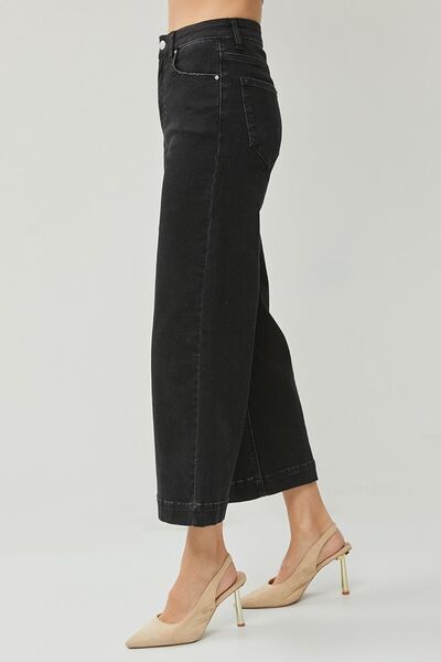 Side view of RISEN High Rise Wide Leg Ankle Jeans in black, showcasing a chic, cropped silhouette with stylish footwear.