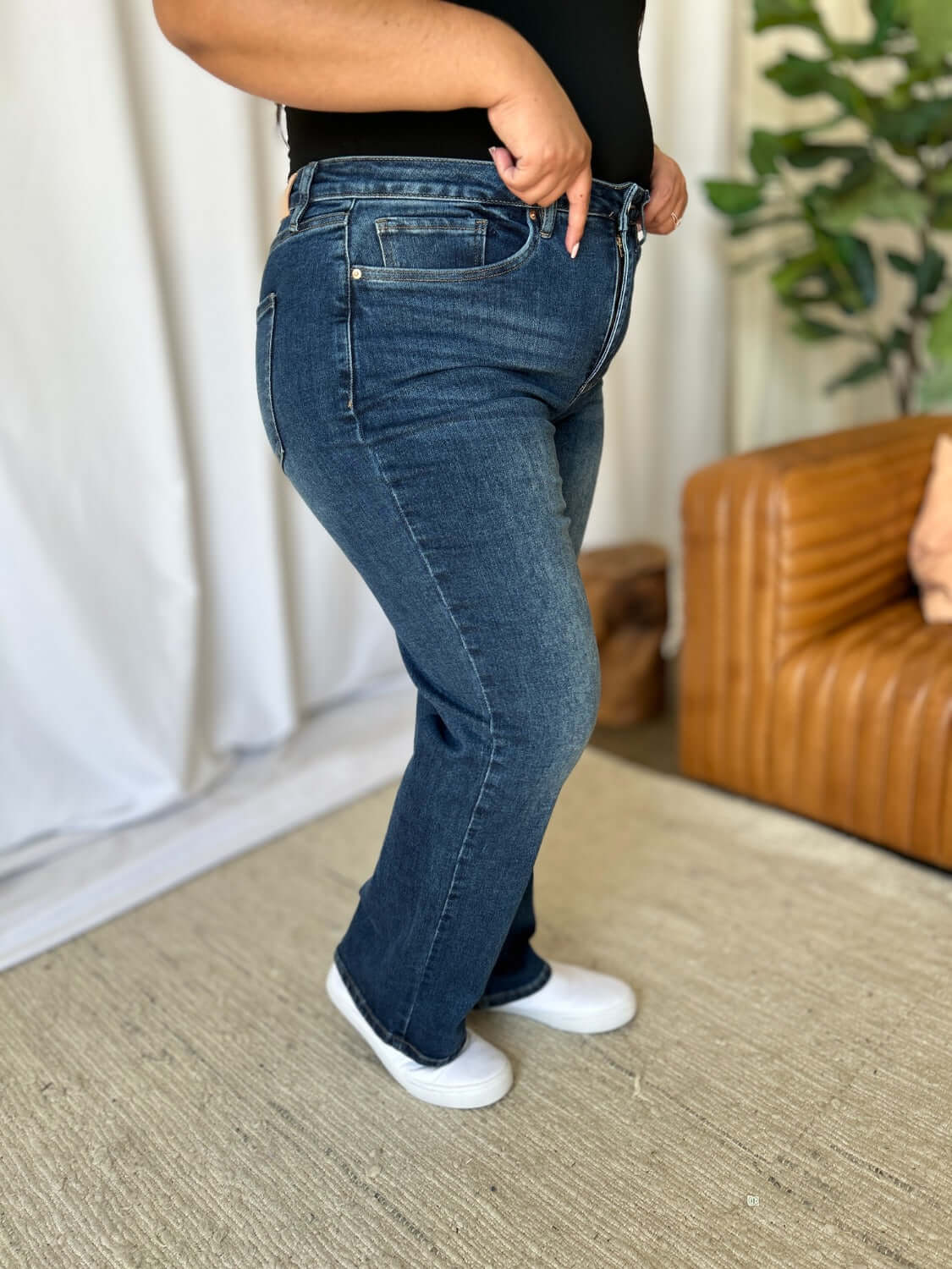 Woman wearing RFM Full Size High Rise Straight Tummy Control Jeans for a flattering, streamlined look