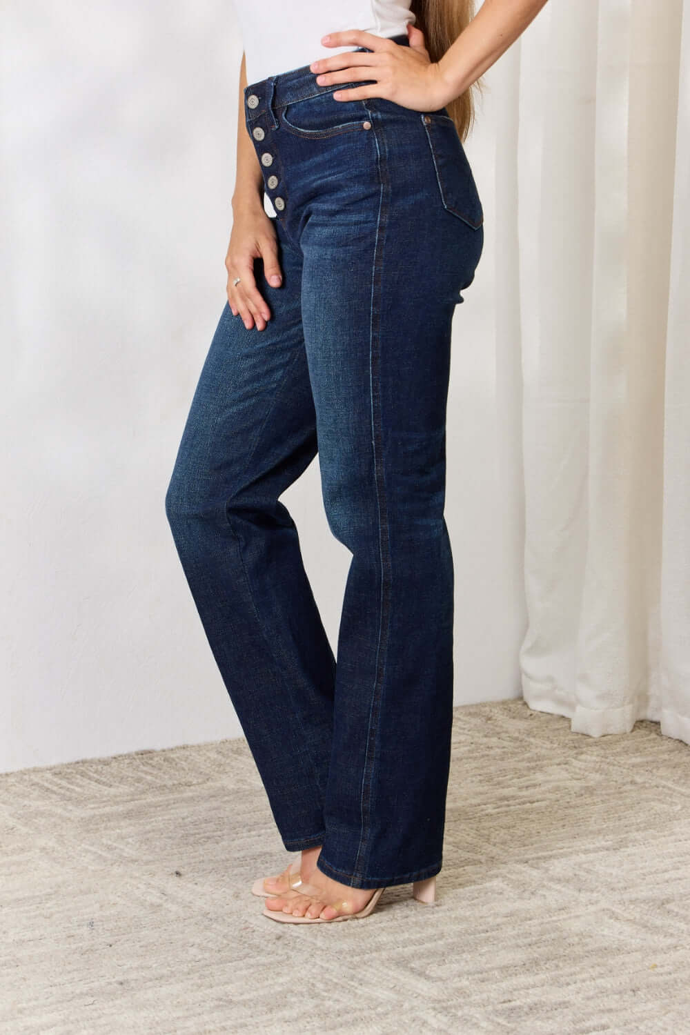 High-waisted button-fly straight Judy Blue jeans in dark wash, showcasing a flattering fit, slight stretch, and front pockets.