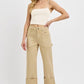 Plus size high rise wide straight cuffed patch jeans styled with a cropped top and sandals.