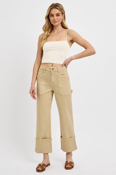 Plus size high rise wide straight cuffed patch jeans styled with a cropped top and sandals.