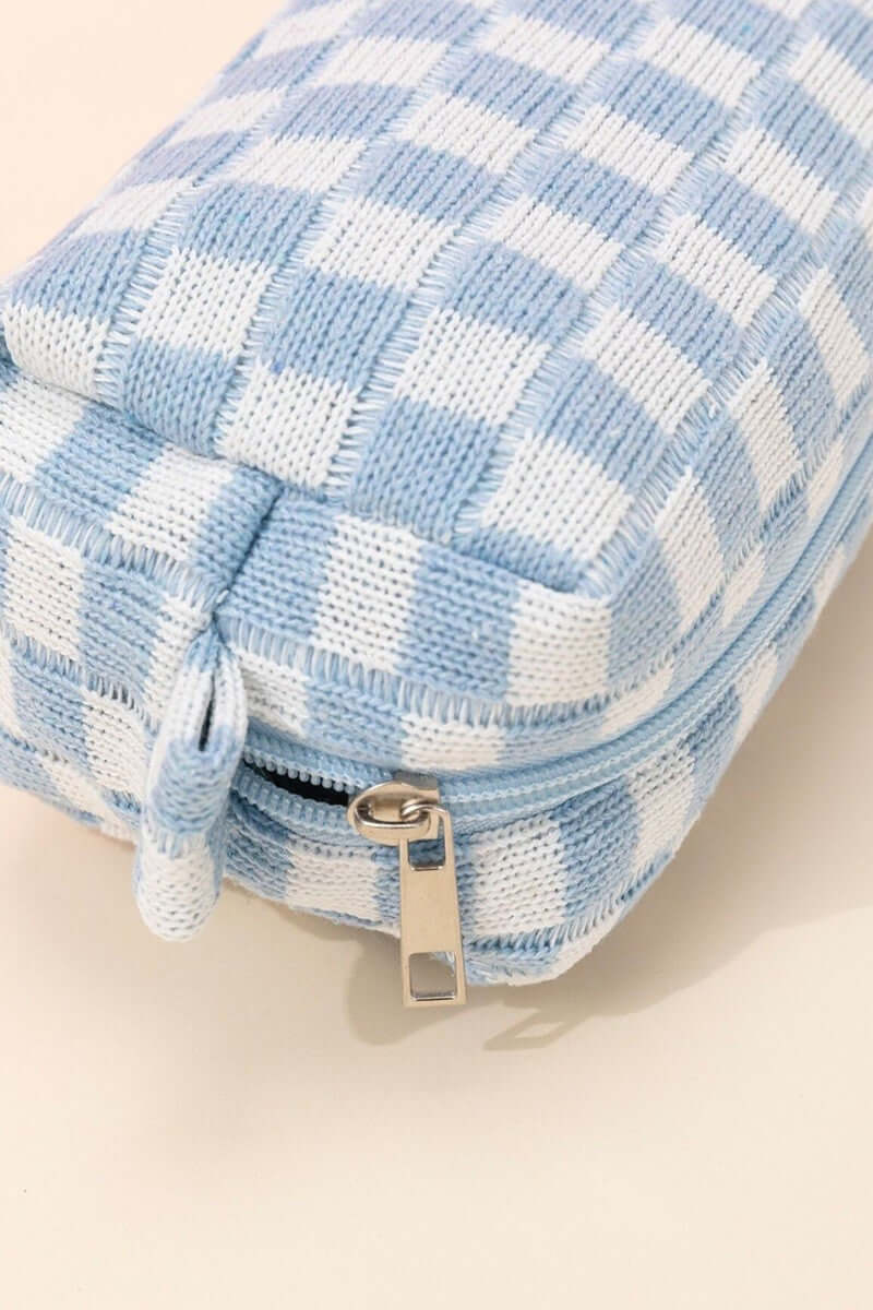 Stylish blue checkered pattern knitted cosmetic pouch with zipper closure, perfect for organizing makeup essentials.