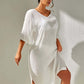 Woman wearing white slit V-neck flounce sleeve cover-up with sheer, backless design, and no-stretch 100% polyester fabric.