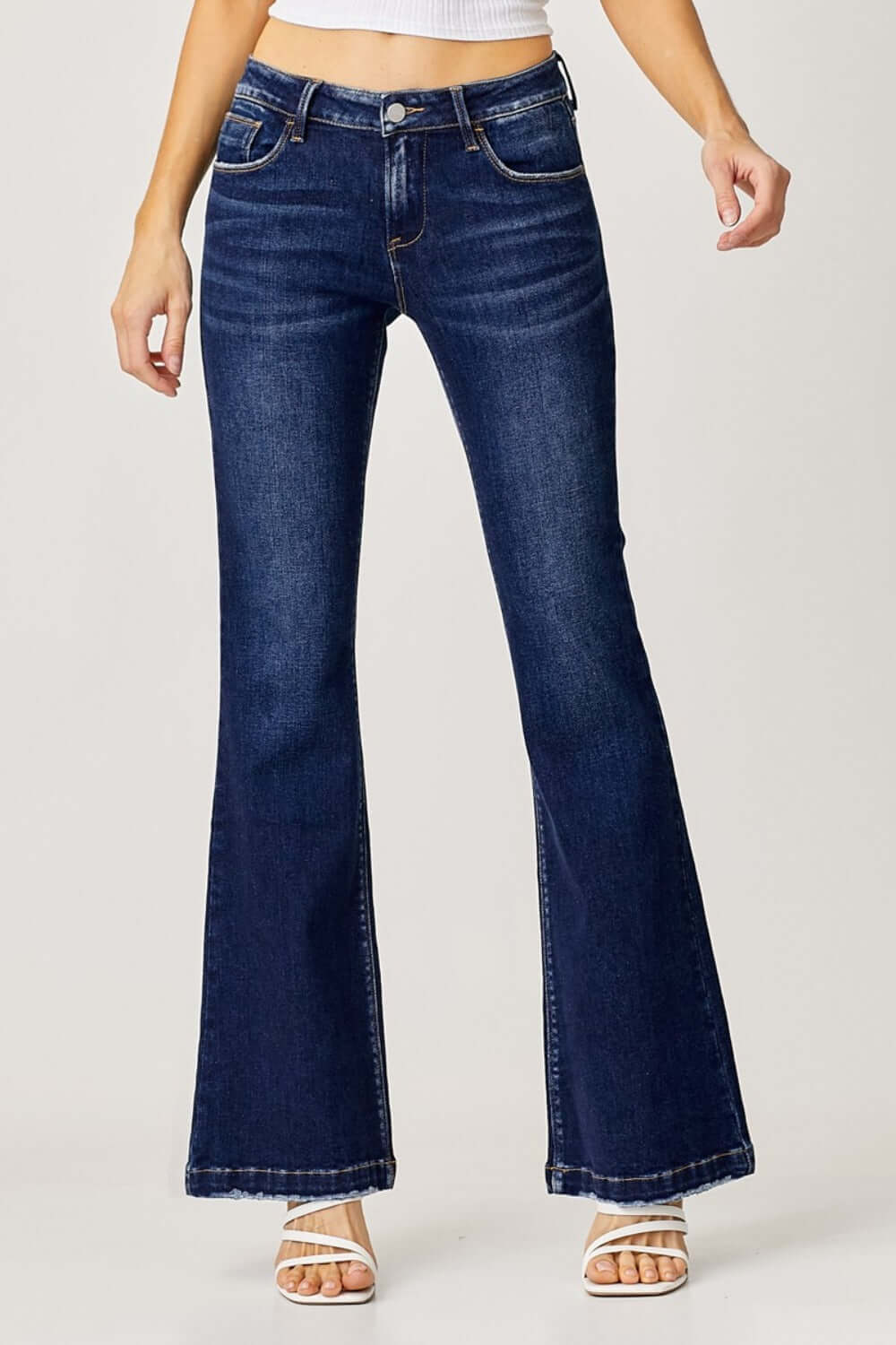 Woman wearing RISEN Full Size Low Rise Flare Jeans with retro vintage denim style and flattering silhouette.