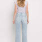 90's Vintage Super High Rise Flare Jeans in light wash denim worn by model facing back showcasing flared legs and high-rise waist