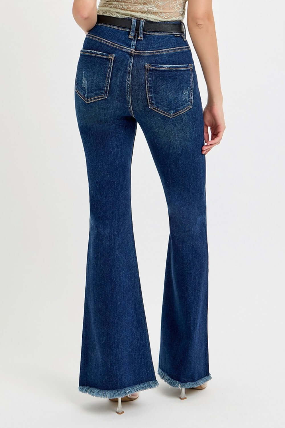 RISEN Tummy Control Frayed Hem Flare Jeans with Belt in dark wash, high-rise fit, rear view showing flare legs and back pockets.