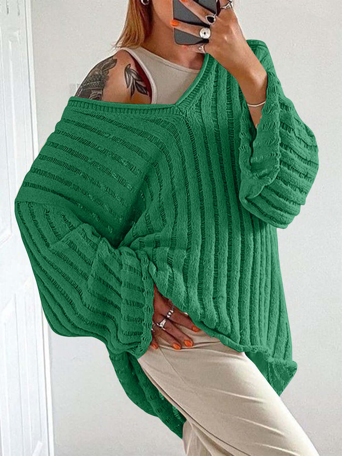 Woman wearing green Bella Road V-Neck Long Sleeve Sweater looking stylish and cozy in trendy fall colors.