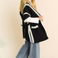 Model wearing a Davi & Dani fuzzy trim cardigan paired with wide-leg jeans, showcasing a cozy and chic style.