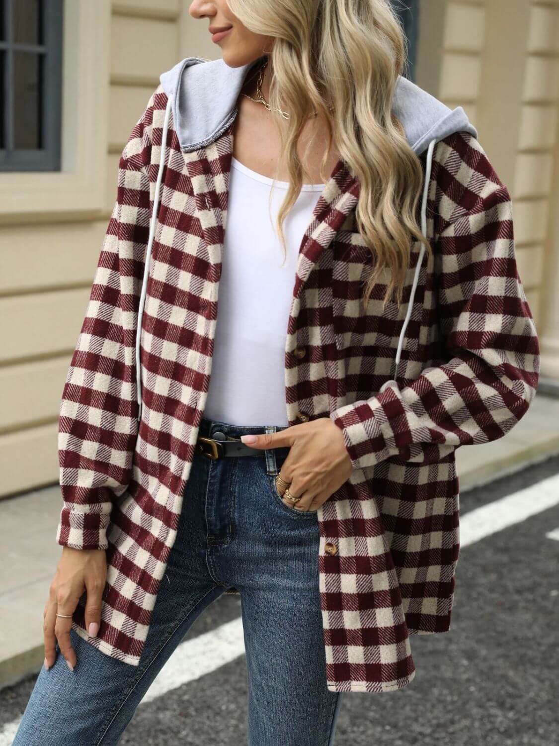 Woman wearing Bella Road Drawstring Plaid Long Sleeve Hooded Jacket, white top, and jeans, featuring a cozy plaid pattern and adjustable drawstring.