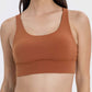 Stylish crisscross scoop neck active tank in earthy orange, perfect for workouts and everyday wear.