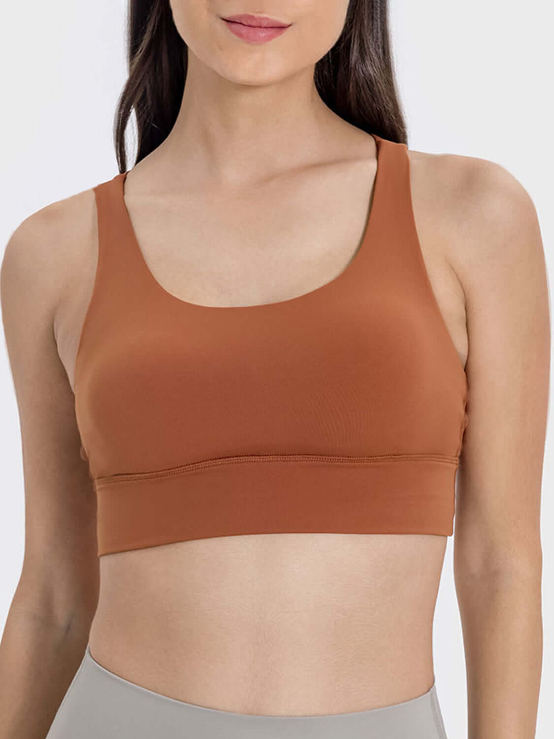 Stylish crisscross scoop neck active tank in earthy orange, perfect for workouts and everyday wear.