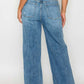 Woman showcasing the back of bytos High Rise Wide Leg Jeans with Pockets in a stylish light blue wash.