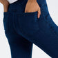 Model showcasing the pocket detail of Basic Bae Pocketed Highly Stretchy Bootcut Jeans in a rich blue color.