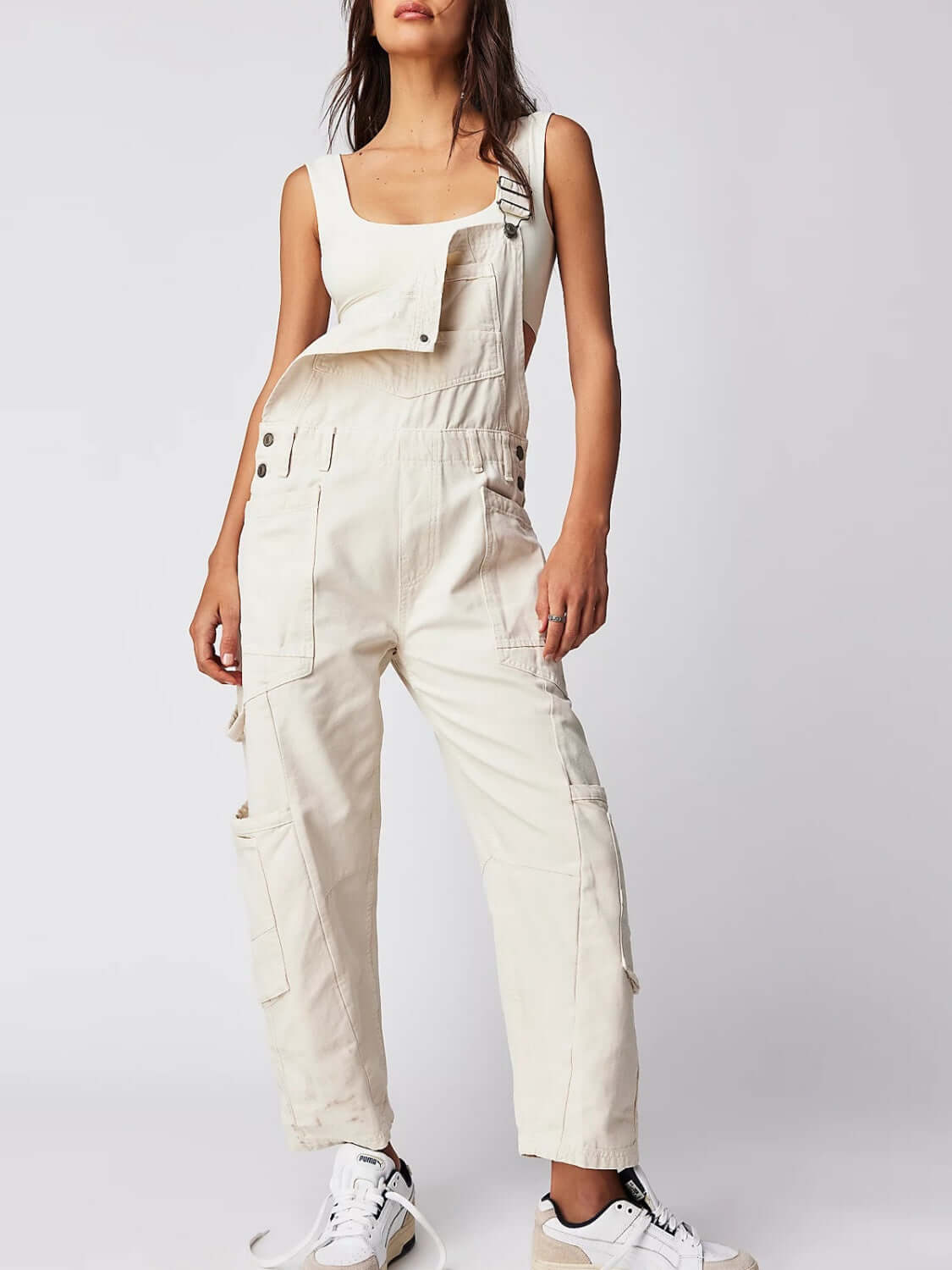 Trendy ivory denim overalls with wide straps and pockets, perfect for any adventure. Fashion meets function in Bella Road style!