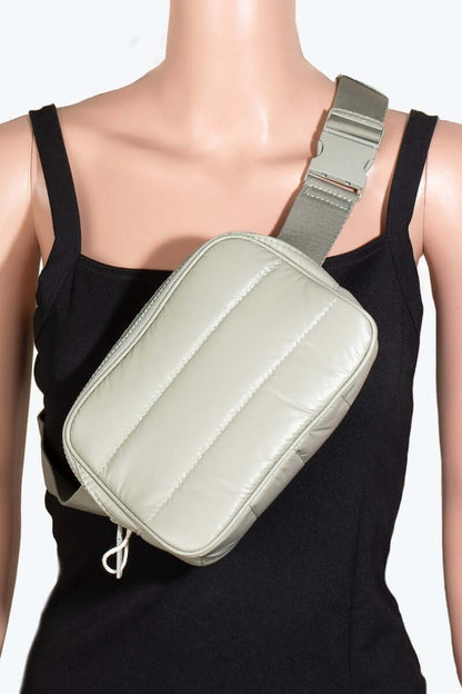 Stylish quilted nylon crossbody bag in light green, worn on a mannequin showcasing its practical design and easy carry style.