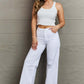 Woman wearing Raelene High Waist Wide Leg Jeans in White from Risen Jeans, showcasing a chic and modern look with a retro flair.