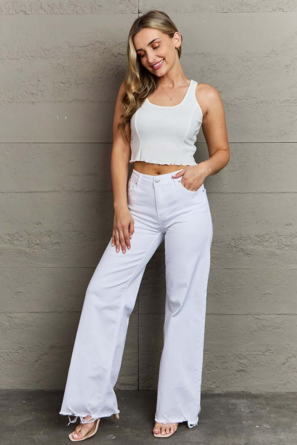 Woman wearing Raelene High Waist Wide Leg Jeans in White from Risen Jeans, showcasing a chic and modern look with a retro flair.