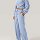 Woman wearing Bella Road Crisscross Round Neck Top and Drawstring Pants Set in light blue, showcasing stylish and comfortable two-piece outfit.