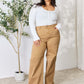 Model wearing Risen Fringe Hem Wide Leg Jeans in a high-waisted fit with a trendy wide-leg design, paired with a white top.