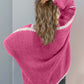 Woman wearing pink dropped shoulder cardigan with open front, showcasing stylish comfort and relaxed fit from the back.