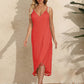 Woman wearing a Backless Tassel Surplice Spaghetti Strap Cover Up Dress in red, standing on a mat with a beige textured background.