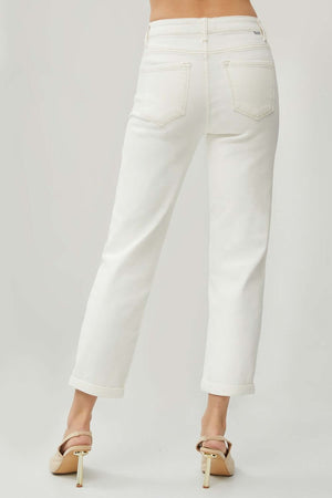 Woman wearing RISEN Full Size High Waist Rolled Hem Straight Jeans in white, showcasing back view with rolled hems and high waist design.