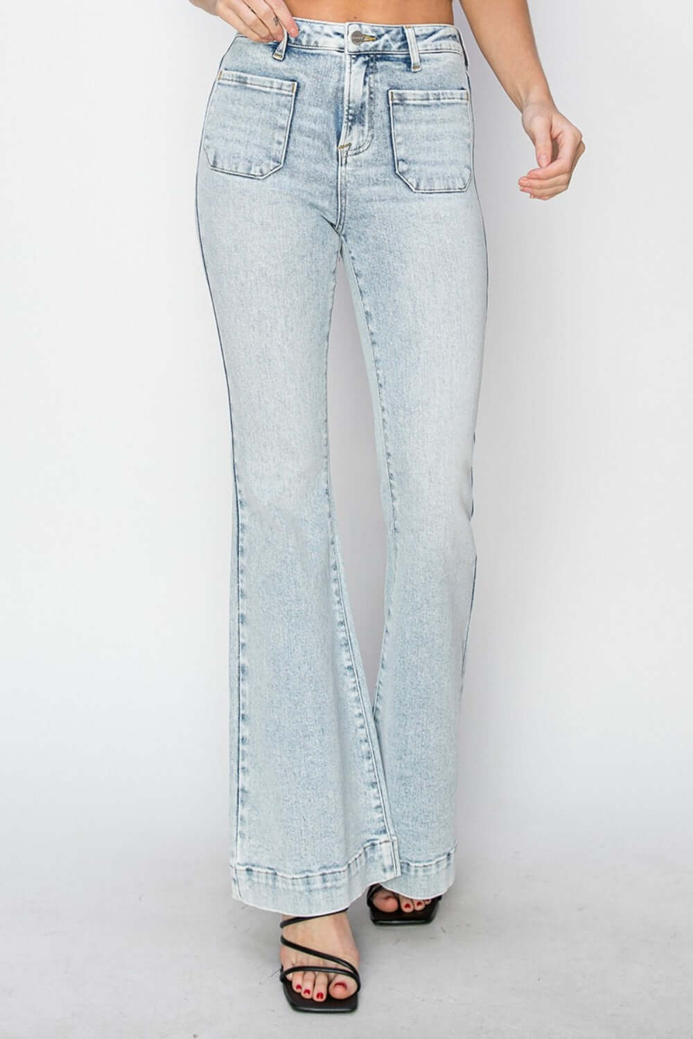 Trendy high rise front patch pocket flare jeans by Risen Jeans in light wash denim, perfect for casual and fashionable looks