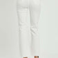 Woman wearing Risen Jeans high rise button fly straight ankle jeans in white, showing back view with stylish minimal design.