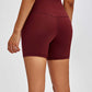 Model showcasing burgundy Millennia high-waist training shorts with a hidden pocket and 5’ inseam from the back.