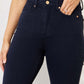 Woman wearing Judy Blue Jeans Garment Dyed Tummy Control Skinny Jeans in deep blue, showcasing flattering and slimming fit.