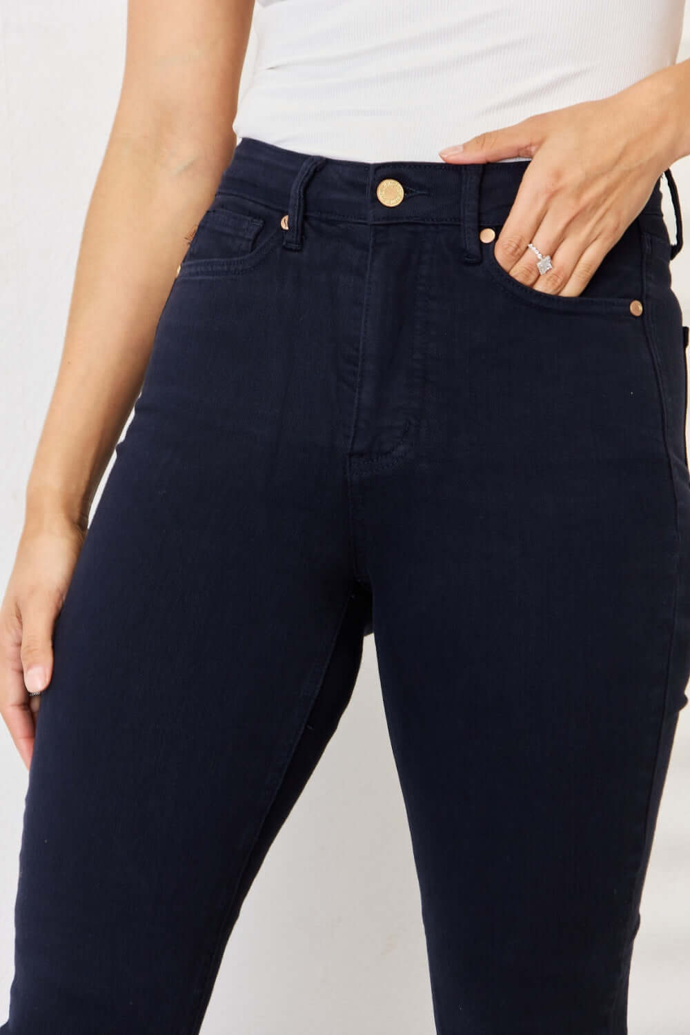 Woman wearing Judy Blue Jeans Garment Dyed Tummy Control Skinny Jeans in deep blue, showcasing flattering and slimming fit.