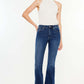 Fashion-forward model wearing Cat's Whiskers Raw Hem Flare Jeans with a retro vibe and a touch of edgy sophistication