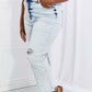 Woman wearing Camille Acid Wash Crop Straight Jeans by Risen Jeans showing trendy distressed detail and casual vibe