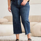 Woman wearing RFM Tummy Control High Waist Raw Hem Distressed Jeans for a sleek, trendy look with slimming fit.