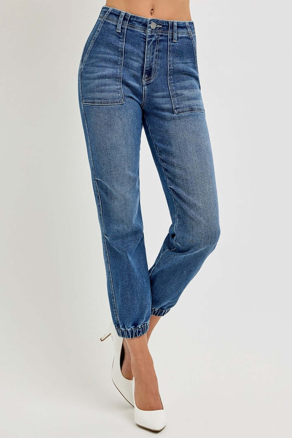 Stylish high-rise ankle jogger jeans with elastic cuffs, showcasing a sleek fit and comfortable stretch denim, paired with heels.