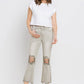 Woman wearing Lovervet distressed raw hem cropped flare jeans with white tee and sandals.