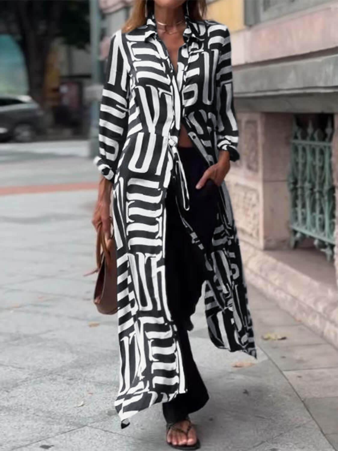 Woman wearing Bella Road Contrast Collared Neck Long Sleeve Longline Shirt, black and white pattern, stylish and playful design