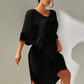 Woman wearing a black slit V-neck flounce sleeve cover-up. Backless and sheer with no stretch, made of 100% polyester.