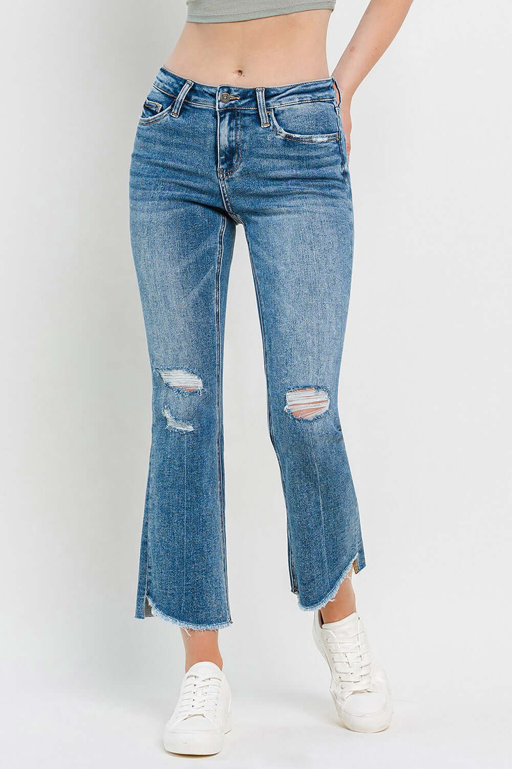 Mid Rise Distressed Cropped Flare Jeans with stylish ripped details and a vintage-inspired cropped flare leg.