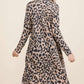 Model showcasing the Celeste Leopard V-Neck Long Sleeve Cardigan from the back, highlighting its wild print and cozy fit.