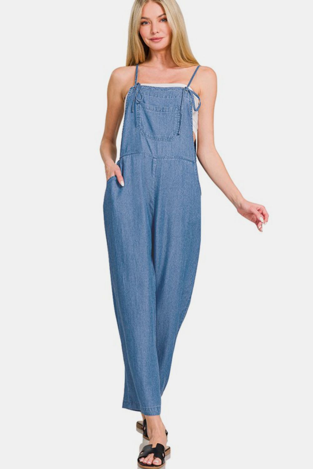 Model showcasing Zenana washed adjustable strap wide leg denim overalls in a relaxed fit, perfect for casual style.