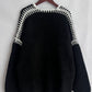 Stylish black cardigan with contrast stitching on a hanger, showcasing trendy open front and dropped shoulder design.