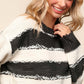 Woman wearing a Haptics Striped Contrast Distressed Sweater, showcasing its trendy stripes and cozy design.