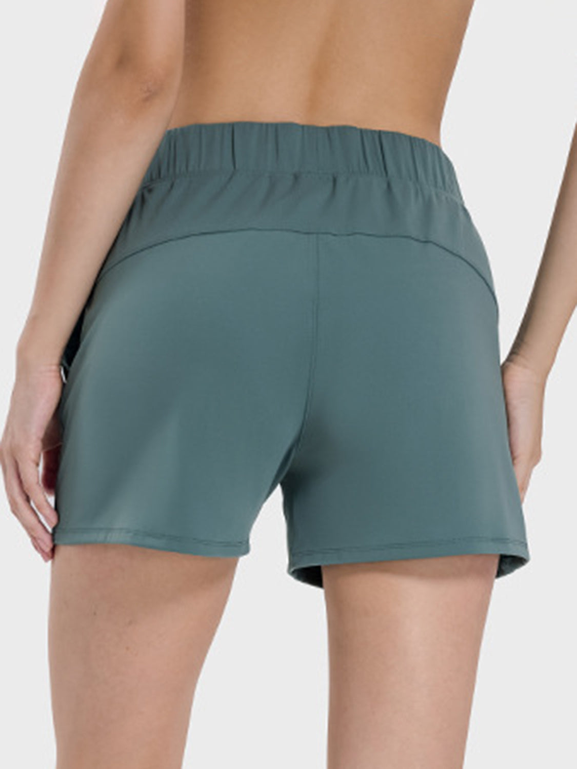 Back view of Millennia Elastic Waist Active Shorts in green, showcasing the comfortable elastic waistband and stretch fabric.