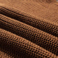 Close-up of Bella Road Pearl Detail Sweater fabric showcasing rich texture in brown with subtle pearl accents.