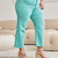 Woman wearing RFM Crop Chloe Full Size Tummy Control High Waist Raw Hem Jeans in turquoise, styled with beige wedge sandals.