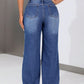 Distressed jeans with roomy pockets viewed from the back, featuring an edgy worn-in look and no stretch material.