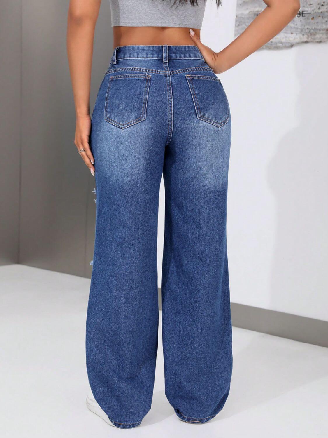 Distressed jeans with roomy pockets viewed from the back, featuring an edgy worn-in look and no stretch material.