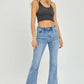 High Rise Frayed Hem Flare Jeans by Risen Jeans paired with a black crop top, showcasing a trendy and retro-inspired look.